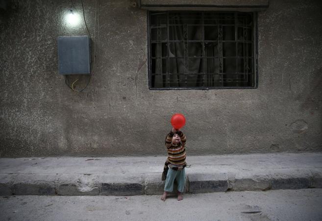 A child plays with a balloon Nov. 13, 2016, in Douma, Syria. In previous years, sanctions by the United States denied industrial parts to Syria and crippled its airline industry. (CNS/Reuters/Bassam Khabieh)