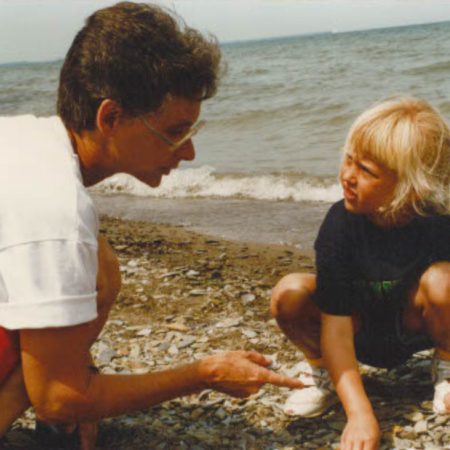 Sister Pat Lupo with a child on the beach